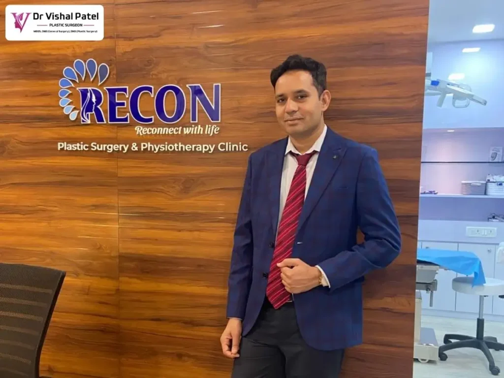 Signage of Recon Plastic Surgery Clinic with Dr. Vishal Patel standing nearby.