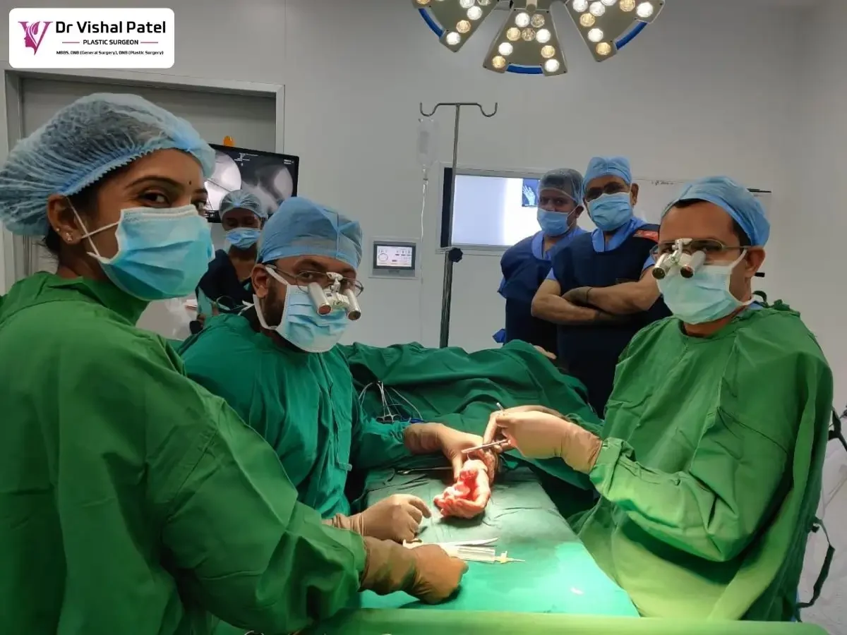 Dr. Vishal Patel doing surgery along with staff surrounded.