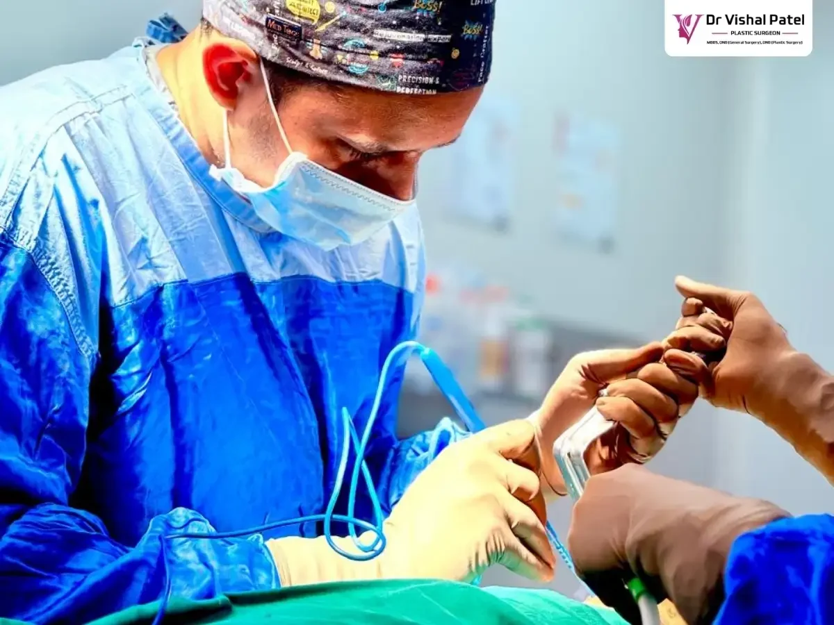 Dr. Vishal Patel inserting breast implant into the breast.