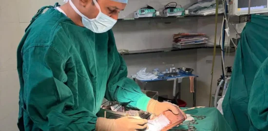 Dr. Vishal Patel doing dermal grafting during a skin grafting surgery.