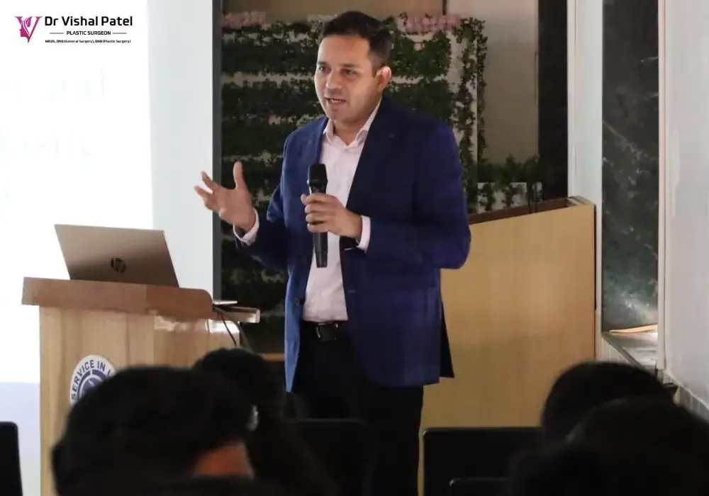 Dr. Vishal Patel holding mic during a presentation at Holy Spirit Hospital, Mumbai.