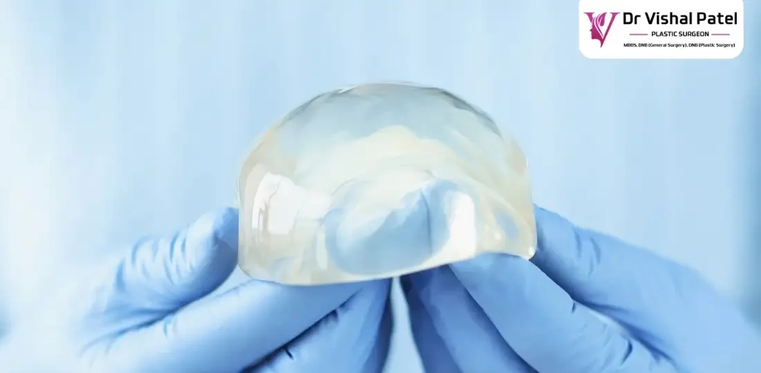 Saline breast implant cup held in hands.