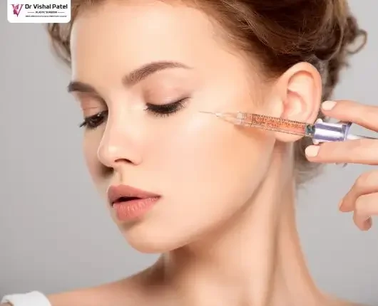 Women's face with Botox being injected near eyes.