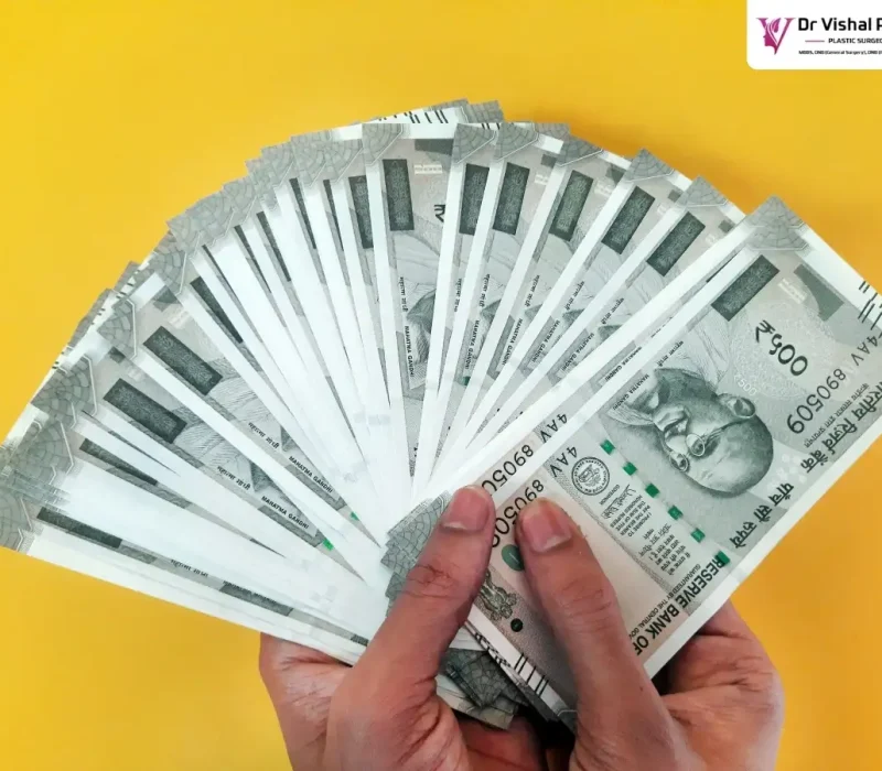 A hand full of 500 currency notes.